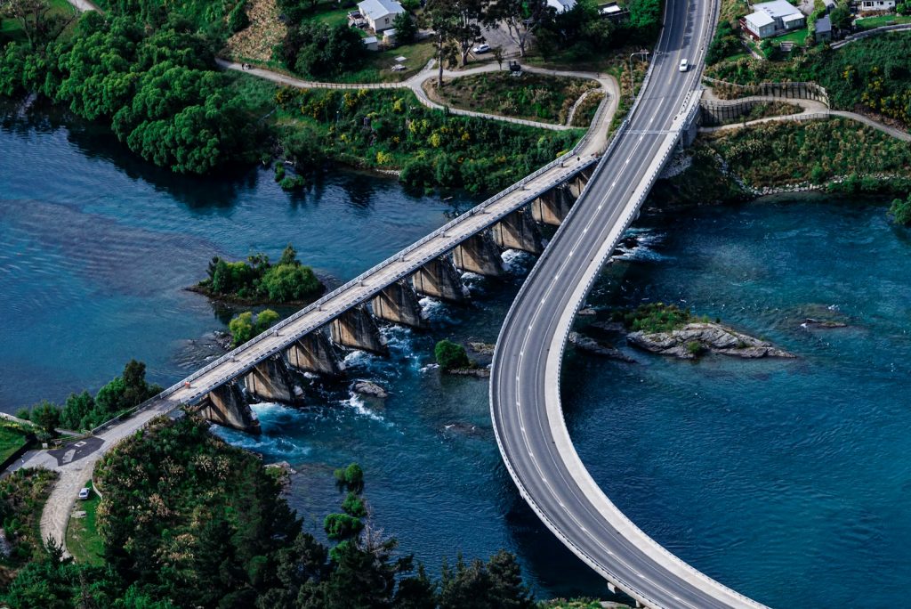 an aerial view of a bridge over a body of water